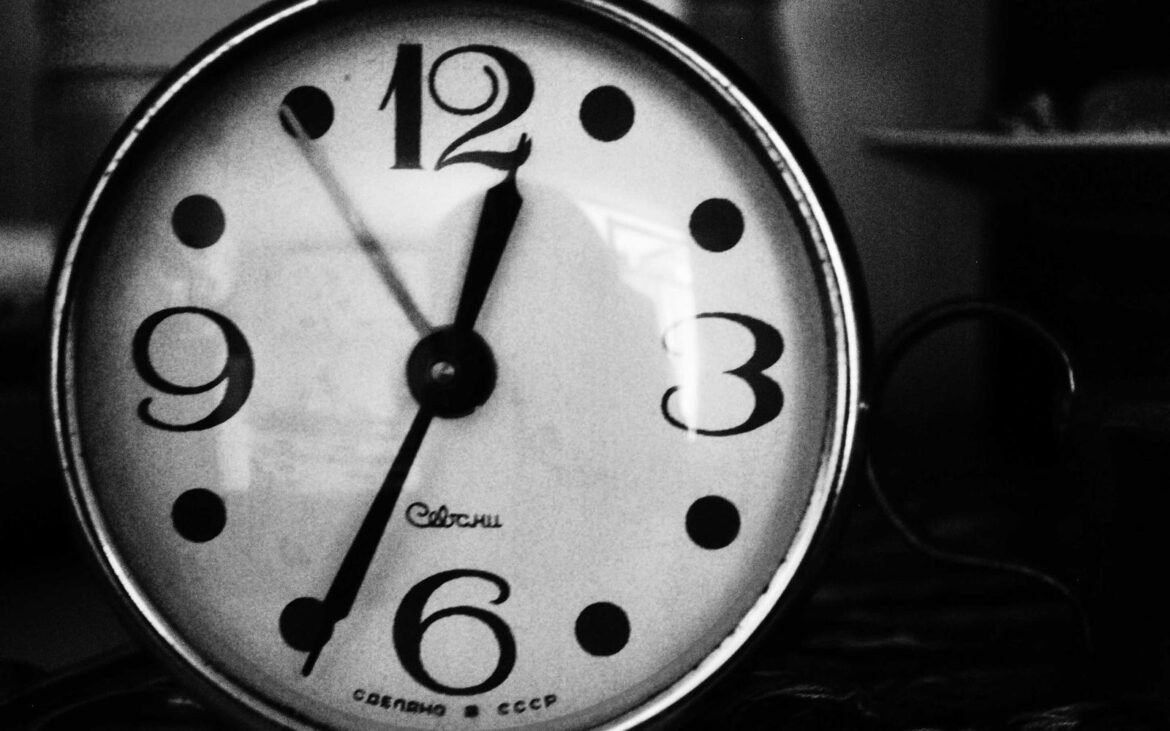 A clock face in soft light, evoking repetition and time