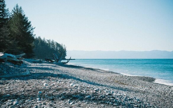A calm sea meeting a pale, open sky at the horizon